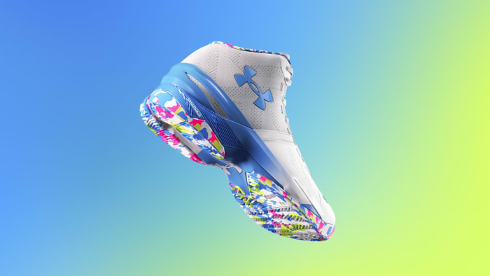 View of white, blue, and pink Under Armour shoe.